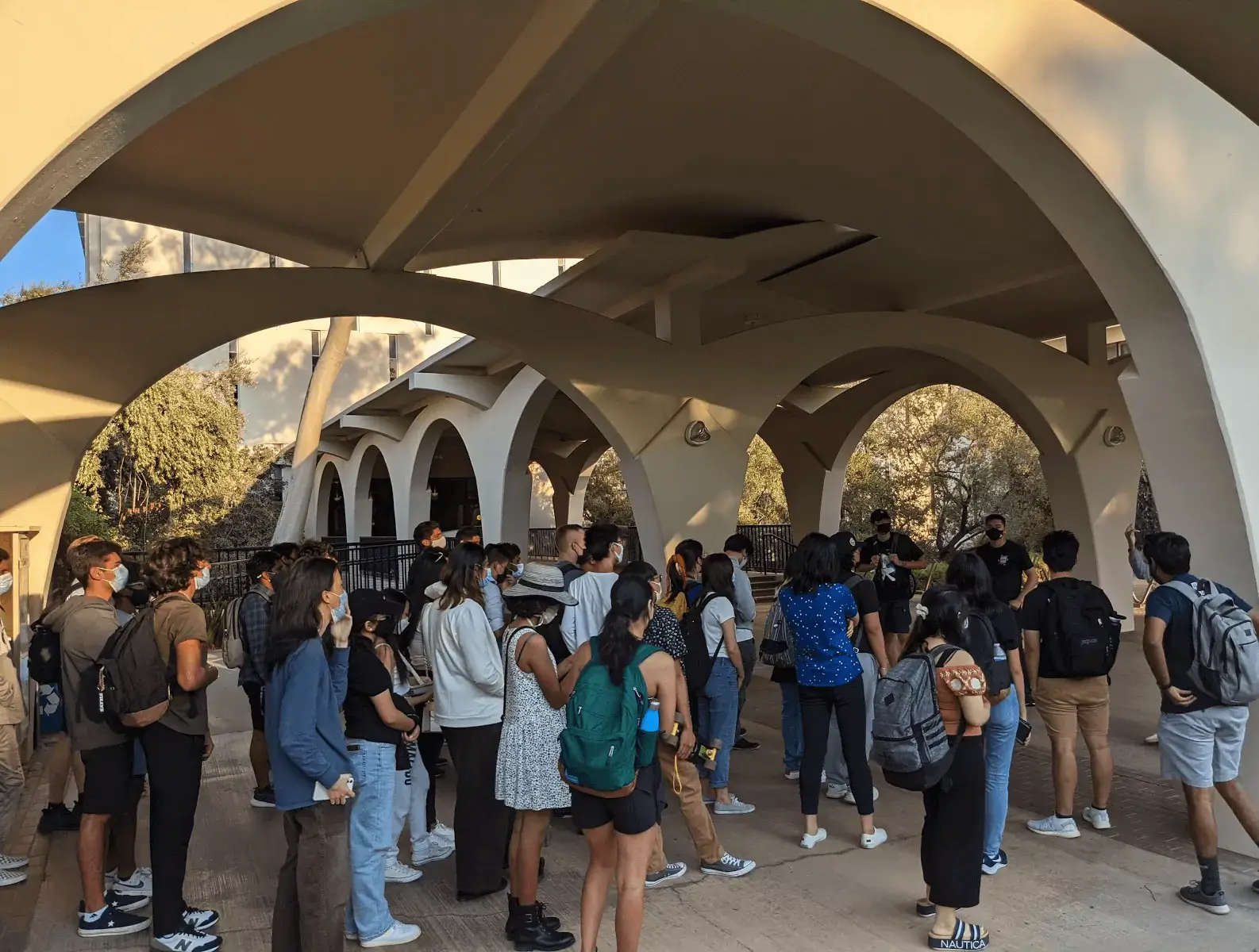 group of students gathering in front of rivera library